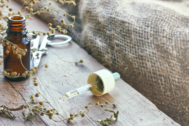 istock Bundle of dried herbs absinthe, bottle of oil 821746972
