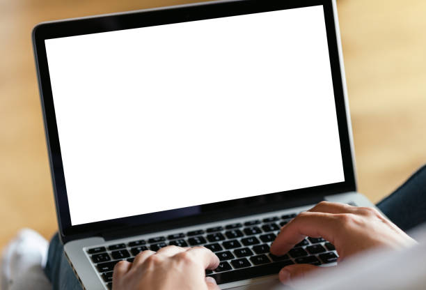 istock Man's hands using laptop with blank screen on desk in home interior. Work concept 821752304
