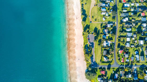 Aerial view on small suburb on a sunny ocean beach. Coromandel peninsula, New Zealand Hohei beach, Coromandel peninsula, New Zealand coromandel peninsula stock pictures, royalty-free photos & images