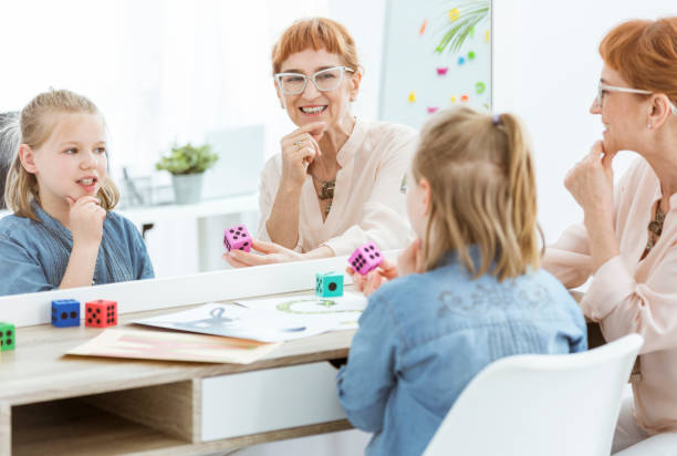 istock Speech therapist and little girl 821759272