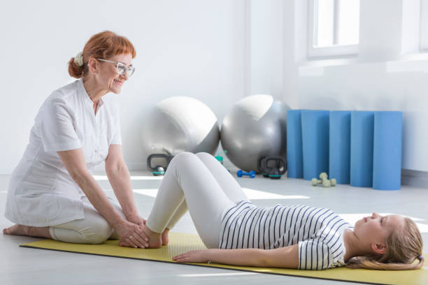 istock Female physiotherapist working with child 821759330