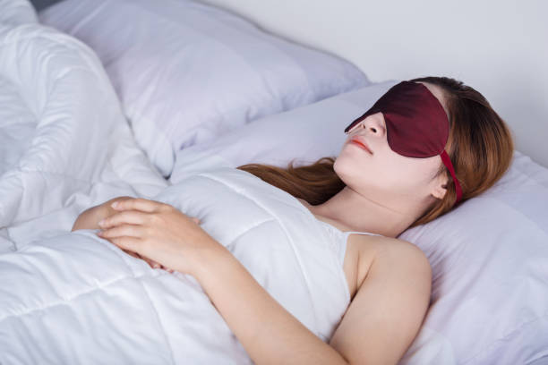 istock woman sleeping on bed with eye mask 821759446