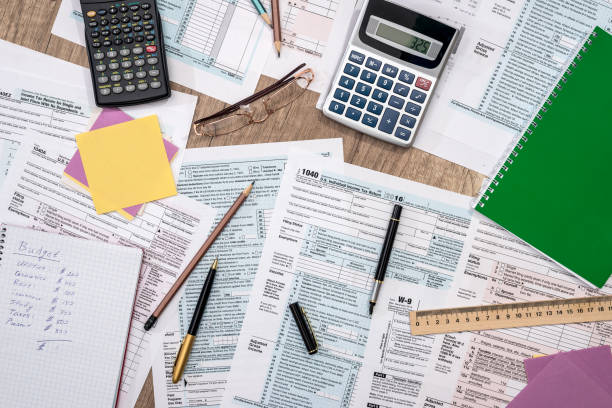 istock tax form with notepad, pen, pencil and calculator 821759606