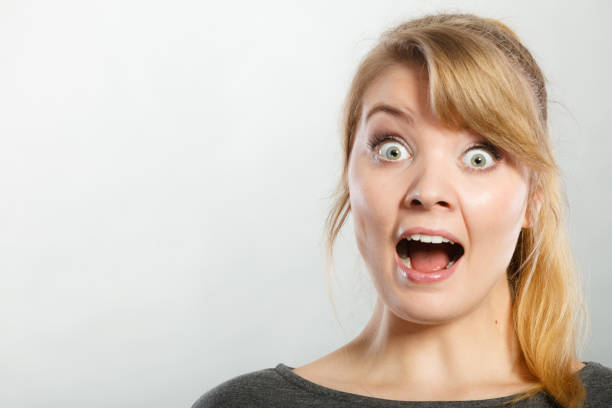 istock Surprised astonished girl with open mouth. 821759634