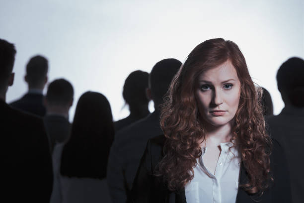 istock Woman standing back to back with dark silhouettes 821760034