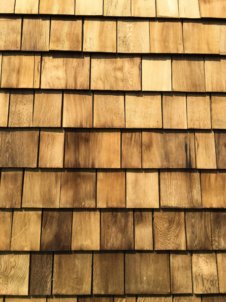 A background of newly roof  installed wooden cedar shingles. stock photo