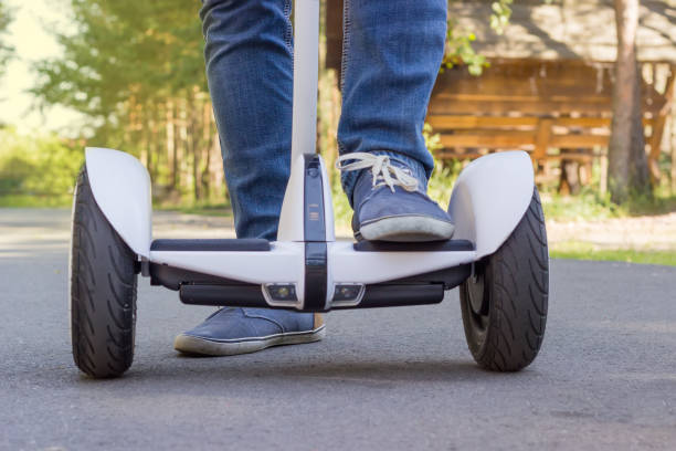 istock Legs of young man stepping on a self-balancing scooter 821768868