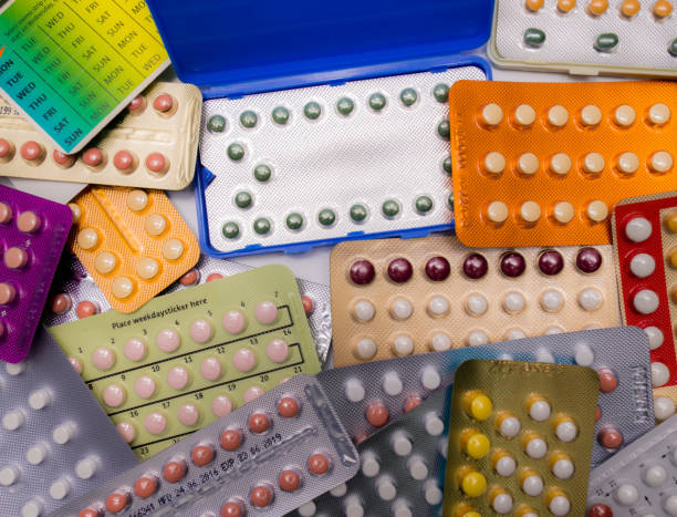 stapel von bunten antibabypillen mit modernen verpackung - contraceptive pill birth control pill sex education stock-fotos und bilder