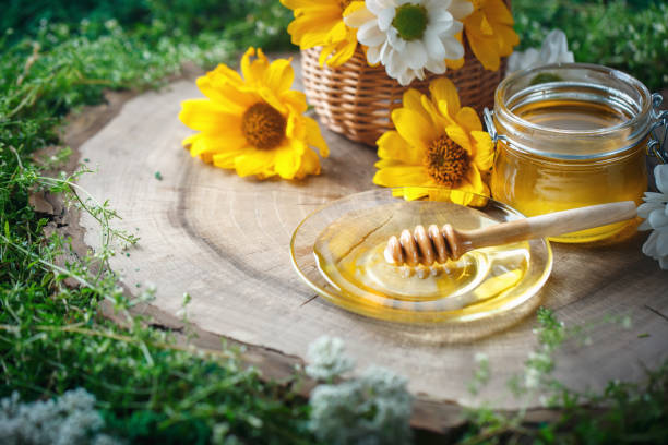 istock Fresh flower honey on a wooden table. Selective focus 821772794