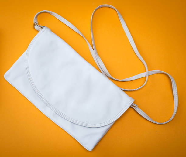 istock white female handbag isolated on yellow background 821779656