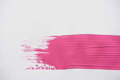 Bright pink stroke smearing on white surface