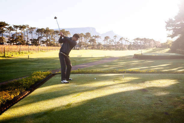 istock Young golfer preparing to drive off the green 821782976