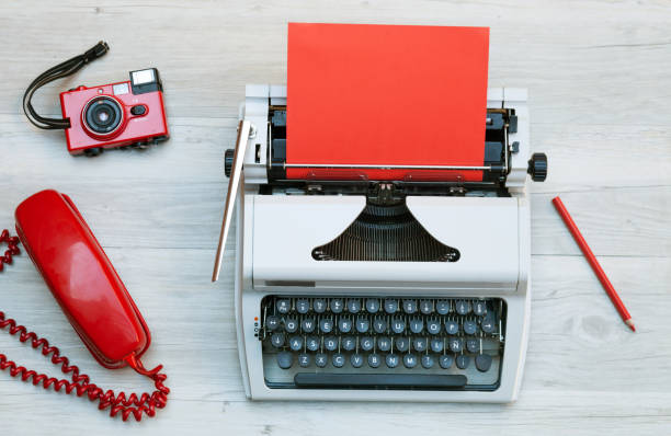 istock White and red typewriter and office supplies 821783906