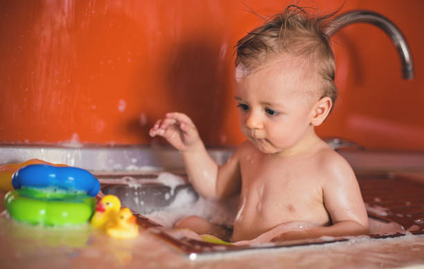 istock Cute Baby Boy in Sink 821786496