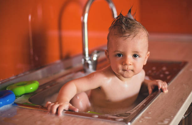 istock Adorable Baby Boy taking a bath in Kitchen 821787130