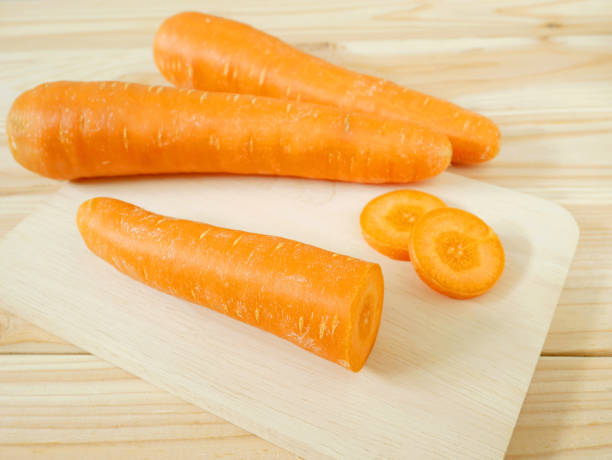 istock Fresh carrots on wooden cutting board 821788006