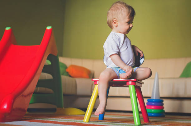 istock Baby boy sitting on a little chair 821794534