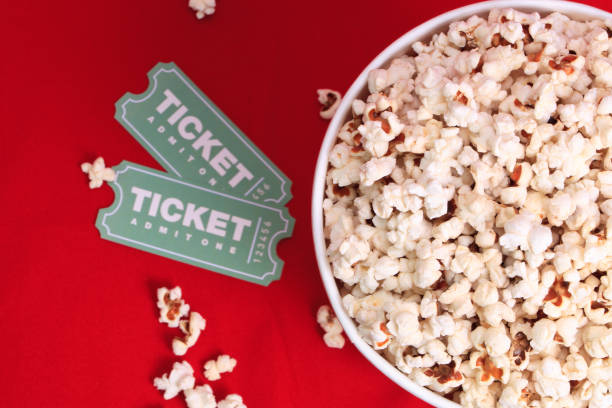 Top view of popcorn and movie tickets stock photo