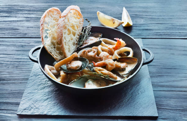 istock Seafood Stew in Saucepan on dark wood background 821795290