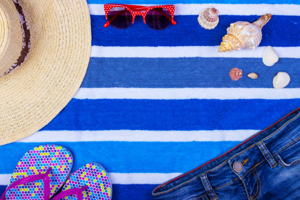 istock Straw Beach Woman's Hat Sun Glasses Top View Seashell Shorts Flip flops with space for text. 821795636