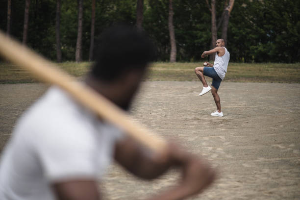 istock young handsome men playing baseball on court, selective focus 821799340