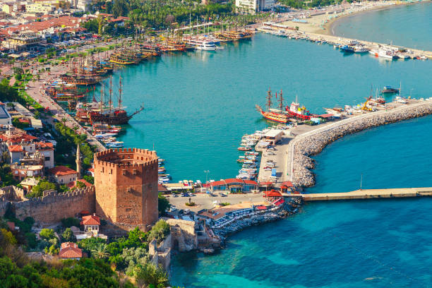 Landscape with marina and Kizil Kule tower in Alanya peninsula, Antalya district, Turkey, Asia. Famous tourist destination with high mountains. Part of ancient old Castle. Summer bright day Landscape with marina and Kizil Kule tower in Alanya peninsula, Antalya district, Turkey, Asia. Famous tourist destination with high mountains. Part of ancient old Castle. Summer bright day alanya stock pictures, royalty-free photos & images