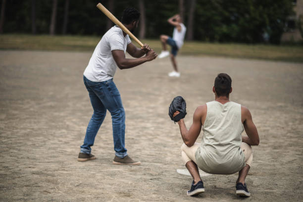 istock group of young multiethnic men playing baseball on court 821801364