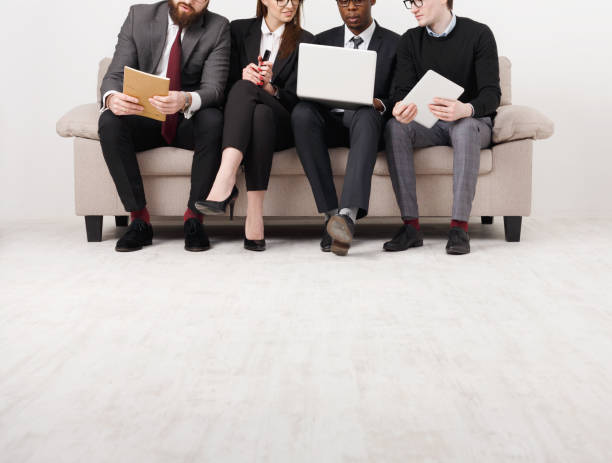istock Business people teamwork crop. Team on couch, partners working together 821803864