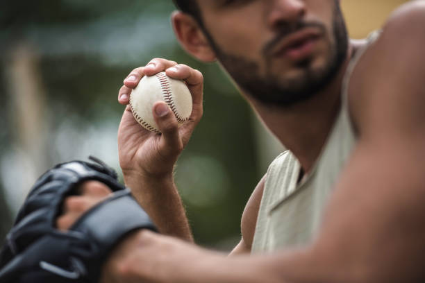 istock young handsome man throwing baseball ball on court 821804524