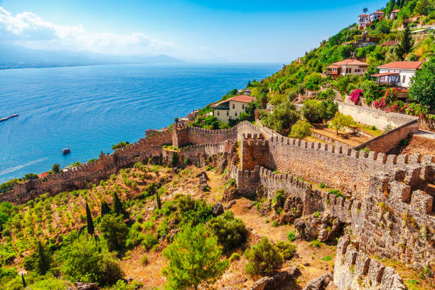 Beautiful sea panorama landscape of Alanya Castle in Antalya district, Turkey, Asia. Famous tourist destination with high mountains. Summer bright day and sea shore Beautiful sea panorama landscape of Alanya Castle in Antalya district, Turkey, Asia. Famous tourist destination with high mountains. Summer bright day and sea shore alanya stock pictures, royalty-free photos & images