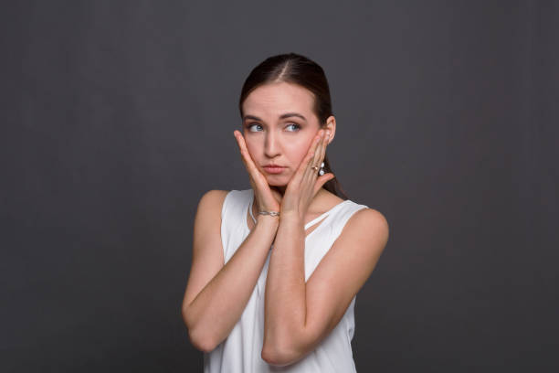istock Beautiful young woman touching her face 821807506