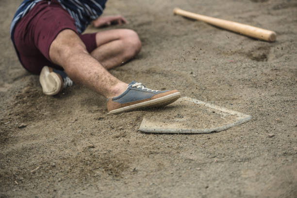 istock male baseball player reaching base during game on court 821808038