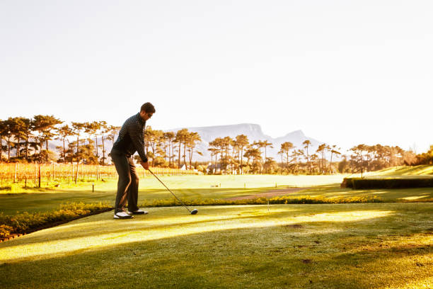 istock Young golfer teeing up the ball on beautiful golf course 821810248