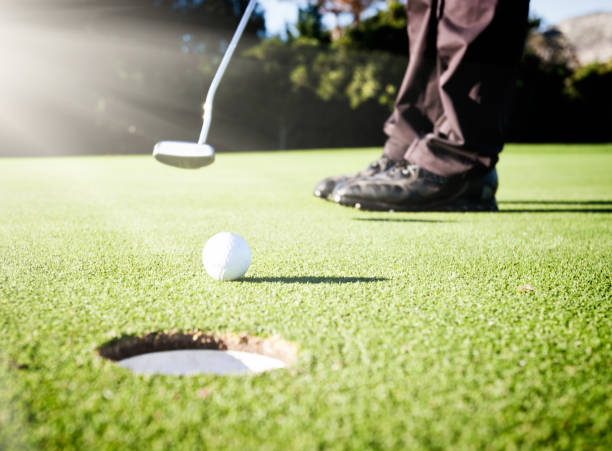 istock Feet of a golfer putting on a golf course 821811446