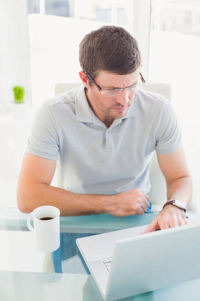 istock Casual businessman using his laptop at desk 821812068