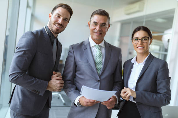 istock Portrait of  three mixed age business people at work 821812676