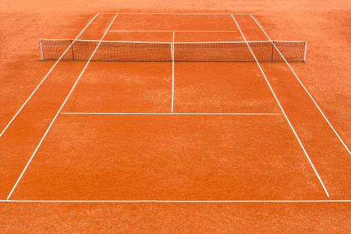 High angle view of empty, red clay, tennis court