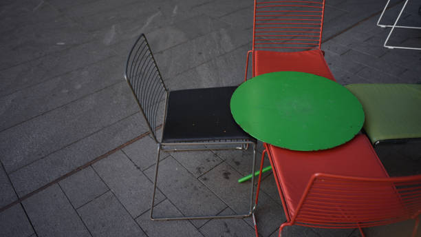 istock Concept image of different coloured chairs and table 821818876