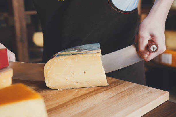 istock Cutting hard cheese in grocery shop 821819520