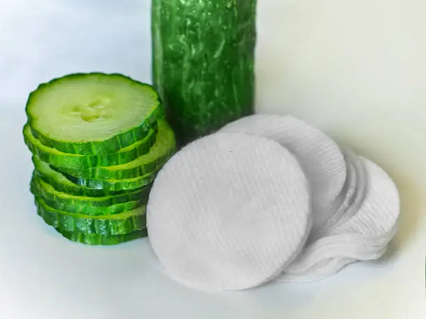 Fresh green cucumber slices and cotton-pads. Organic / natural cosmetic