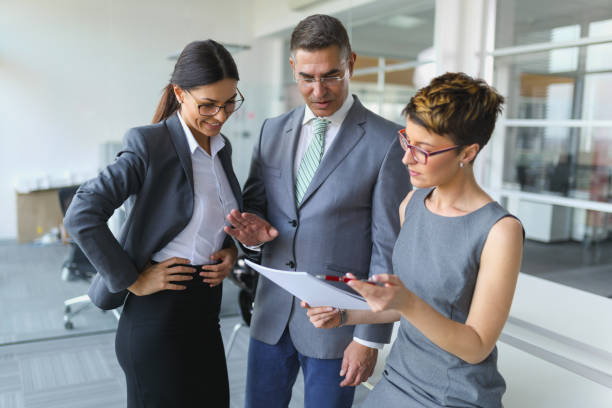 istock Three mixed age business people discussing business strategy 821819794