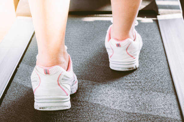 istock Woman's muscular legs on treadmill 821820602