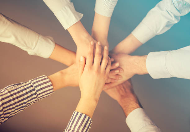 istock Hands stacked in a pile. A symbol of teamwork and trust. 821820998