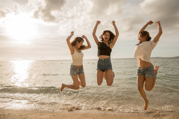 istock Young people having fun on the beach at sunset. 821821228