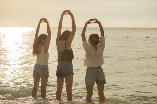 istock Young people having fun on the beach at sunset. 821821364