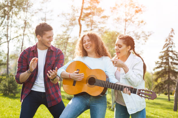 istock Group og friends with guitar in park 821824470