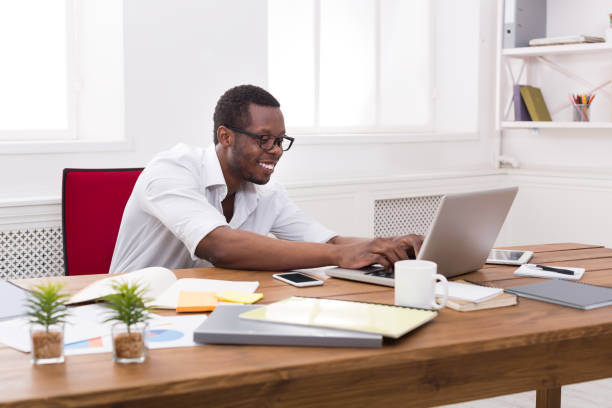 istock Happy black happy businessman in office, work with laptop 821825580