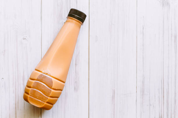 Milk tea in bottle on wooden table