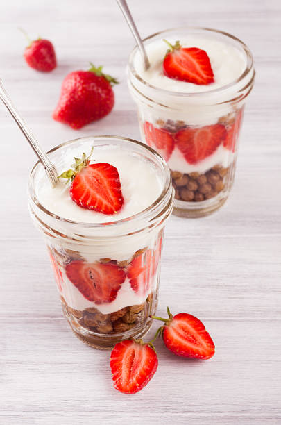 istock Breakfast with strawberry and chocolate balls corn flakes on white wood board. 821827282