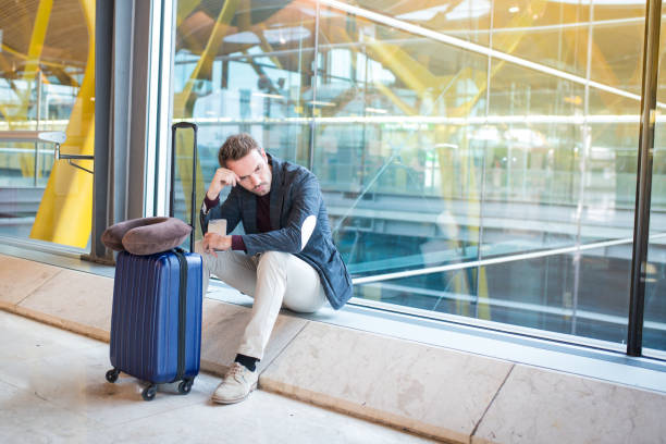 istock Man upset, sad and angry at the airport his flight is delayed 821828908